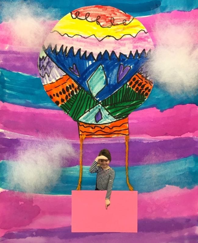 Hot air balloon art made in collage style against a watercolor background