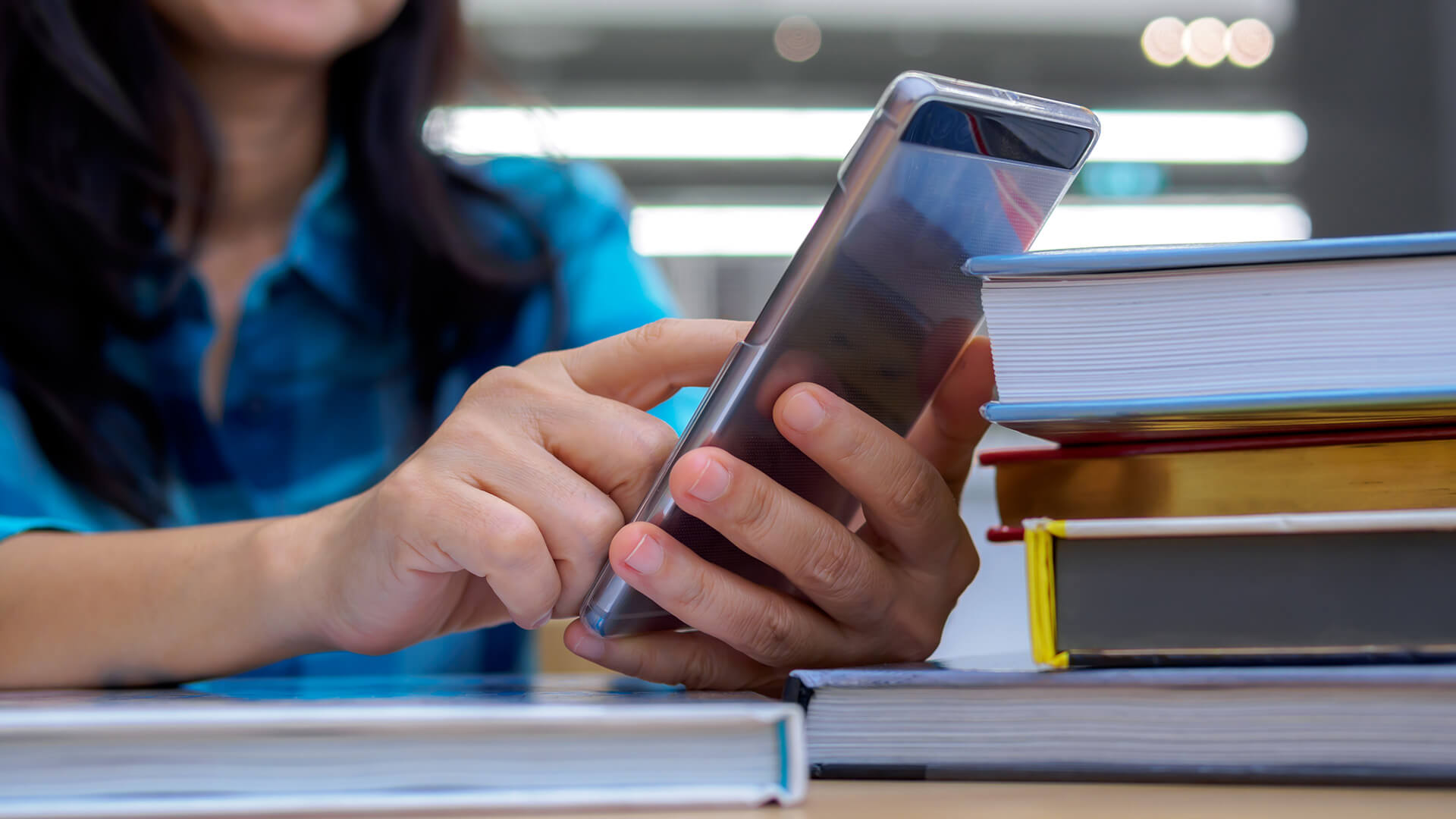 Images of teachers using phone in classroom.