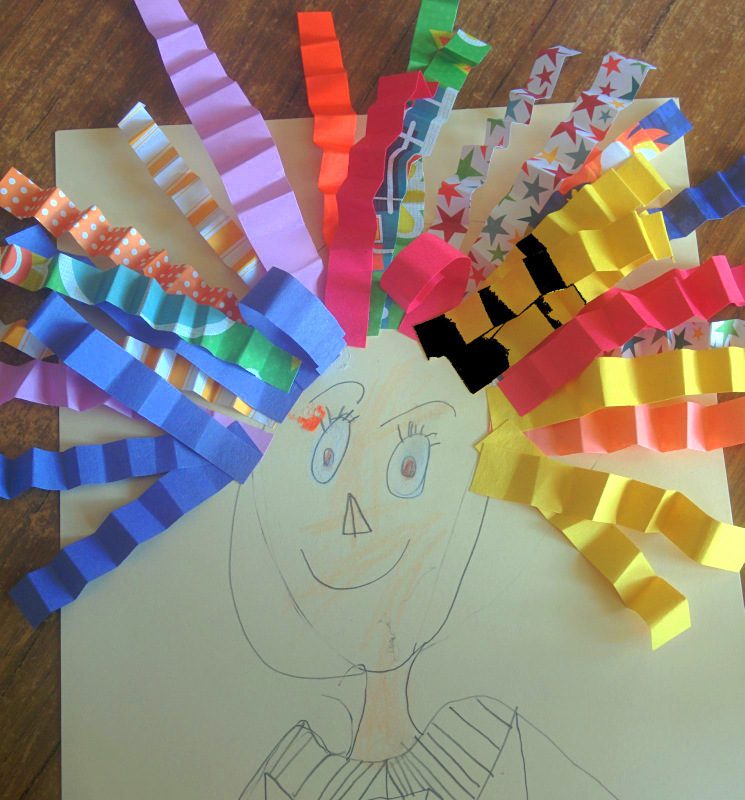 Pencil self-portrait with wild construction paper hair added