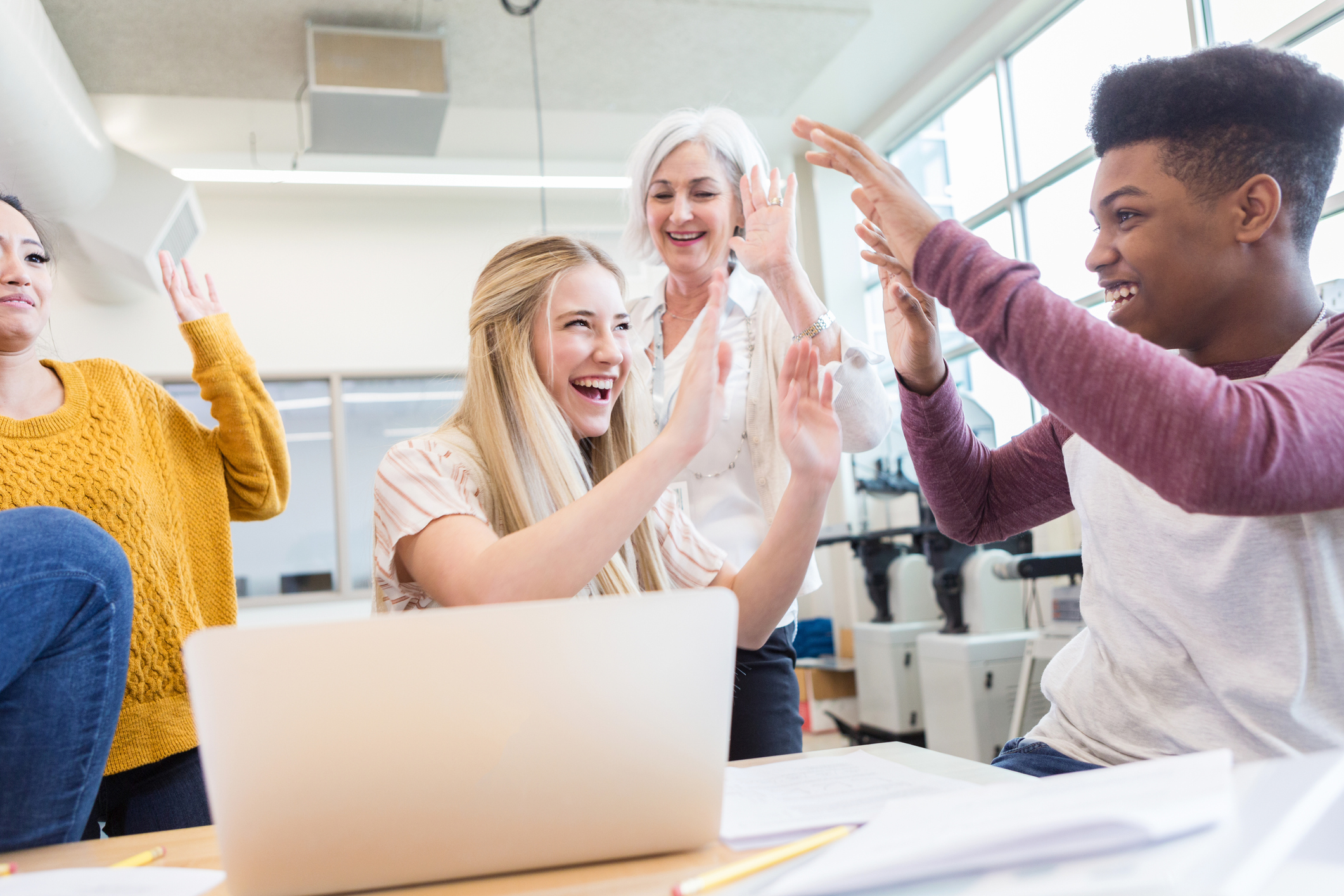 Teenage students playing the unfair game in class