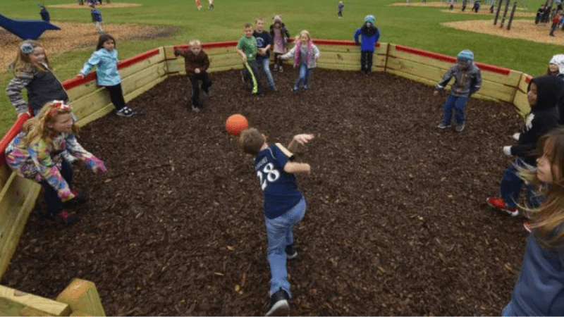 Kids playing gaga ball at recess.