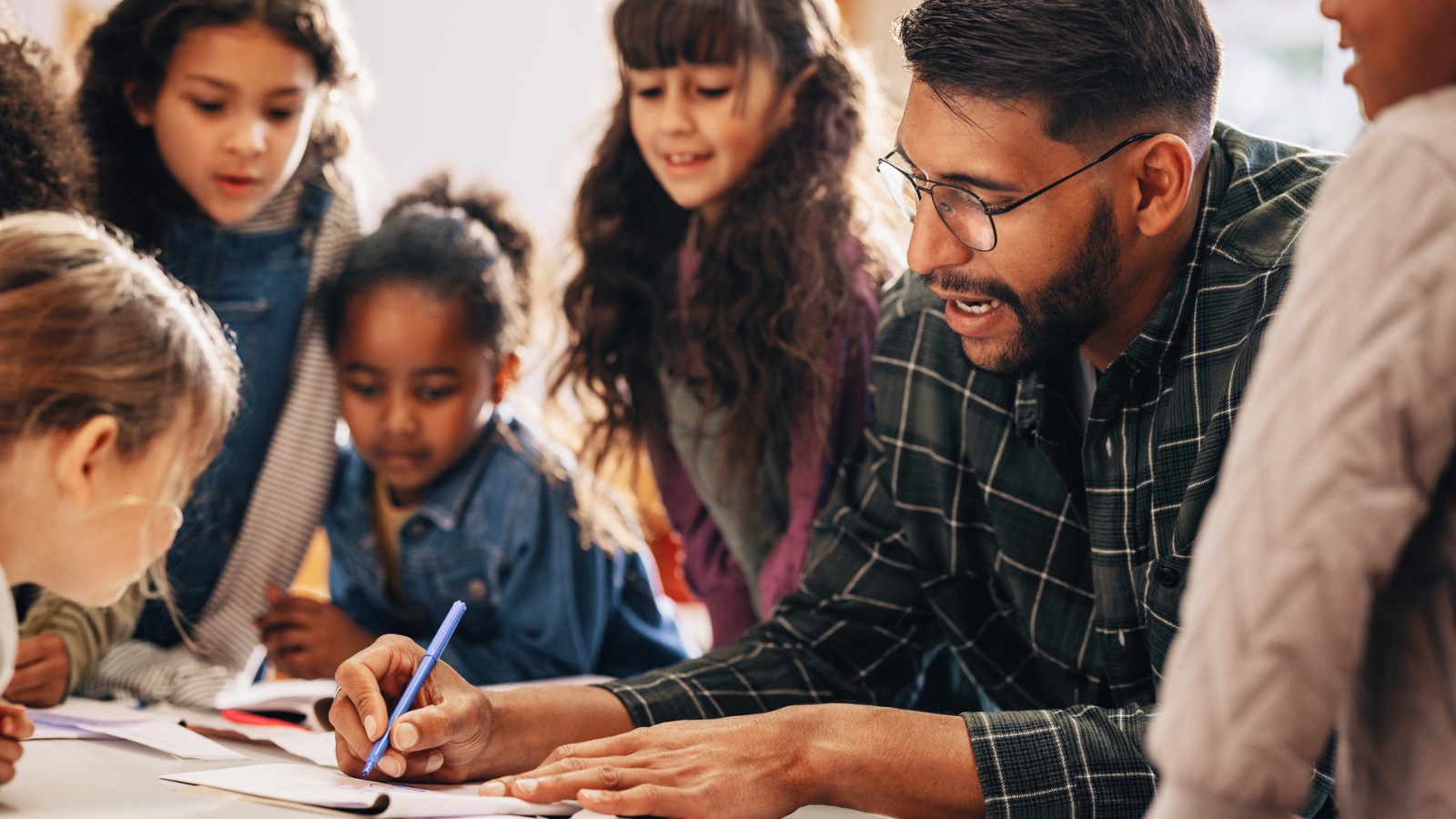 Photo of teacher working with students for article about cut corners